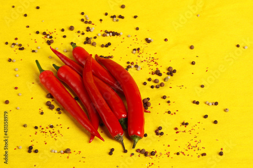 Red chili peppers on a yellow background, a close-up place for the inscription. High quality photo