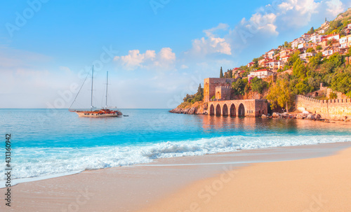 Fototapeta Naklejka Na Ścianę i Meble -  Beautiful sandy beach and soft turqoise Mediterranean sea wave - Landscape of ancient shipyard near of Kizil Kule tower - Alanya peninsula, Turkey