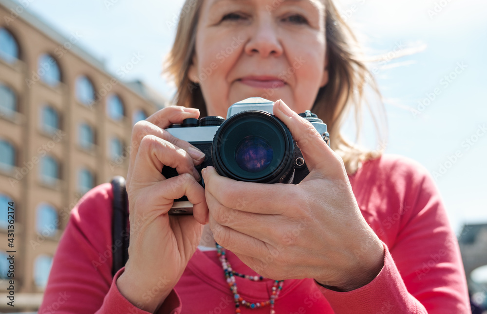 Mature woman holding a film camera.