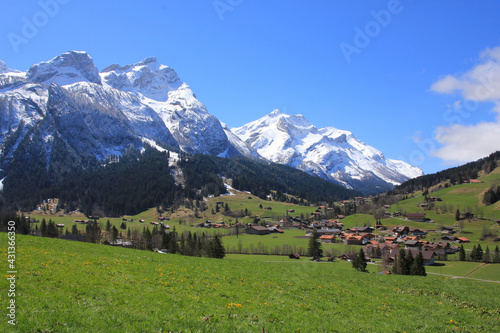 Village Gsteig bei Gstaad and snow covered mountains.