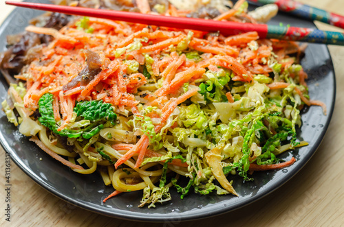 Cooked chicken breast pieces with egg noodles, carrots, and cabbage in a savory chow mein sauce