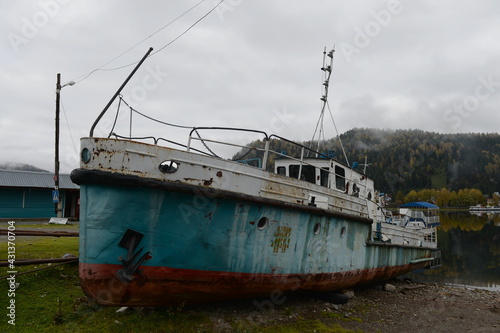 Old river boat on the shore of Lake Teletskoye. Altai Republic