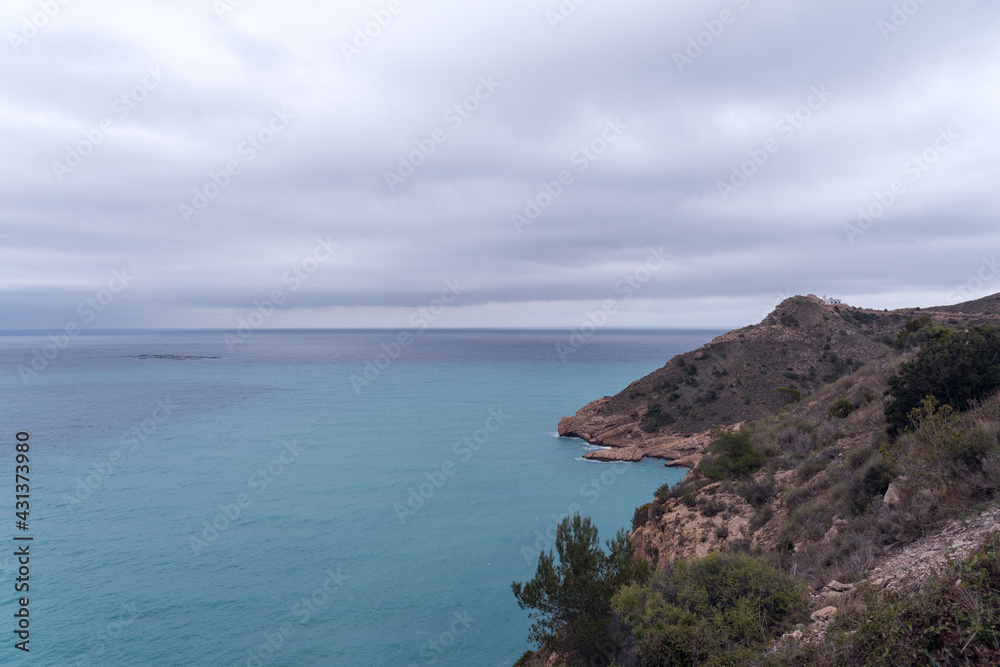 Panoramic view of the Mediterranean coastline, the Mediterranean Sea, a lighthouse and a fish farm.