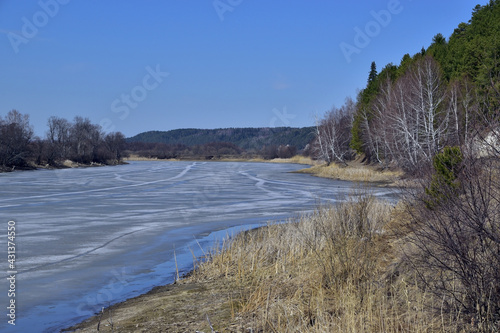 Spring on the shore of a frozen lake