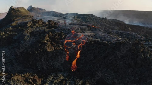 Aerial: Spectacular Volcano Geldingadalir eruption Iceland near Reykjavik 2021 Craters Releasing Red Hot Lava Magma Flowing in to the Valley