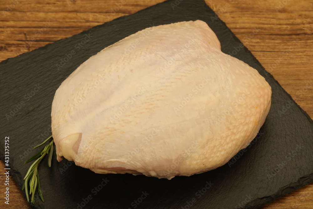 Raw whole chicken breast with skin Raw whole chicken breast with skin