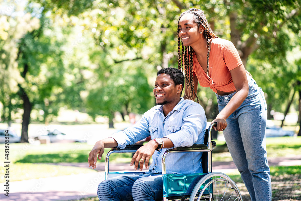 Man in a wheelchair enjoying a walk with his girlfriend. Man in a wheelchair enjoying a walk with his girlfriend.