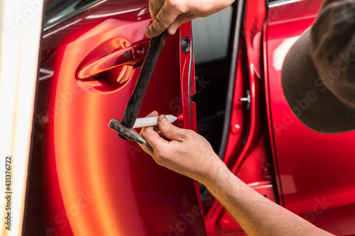 Repair of car dents after an accident without painting the body. PDR photo