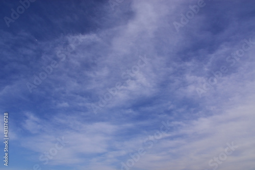 Cirrostratus clouds in the blue spring sky.