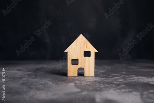 wooden house model on grey background
