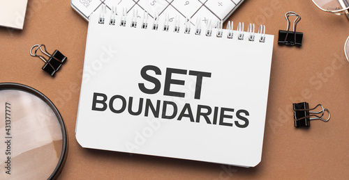set boundaries on notepad with pen, glasses and calculator photo