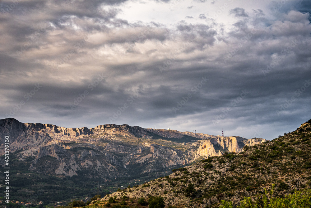 Fototapeta premium Natural landscape of the mountains in the interior of the province of Alicante (Spain), on a day with some clouds.