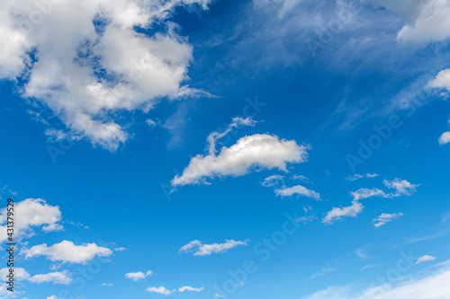 Blue sky with white beautiful clouds as an abstract background.