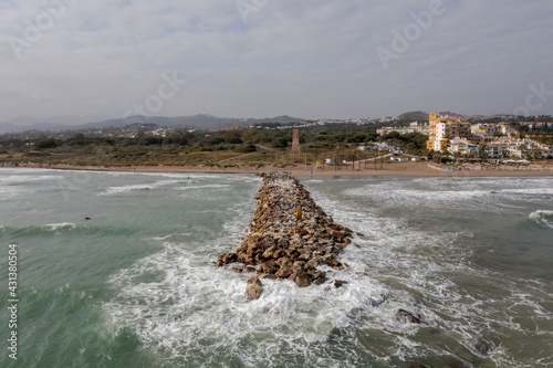 Espigón de la playa de cabopino en la ciudad de Marbella, España photo