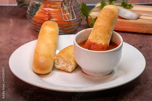 Canvas Print Breadsticks with dipping marinara sauce