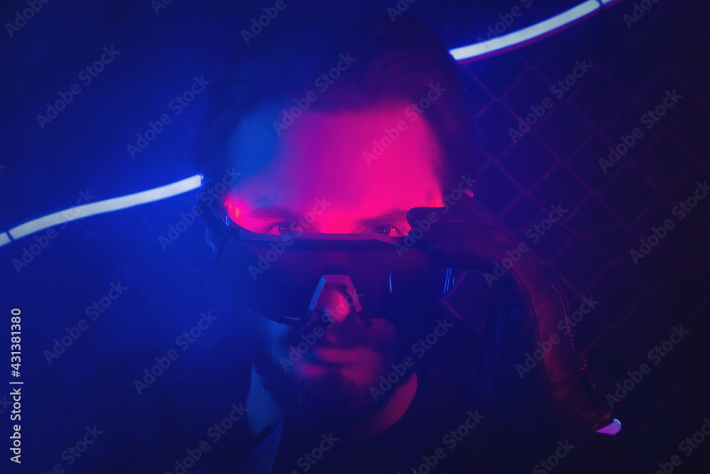 Serious man in the glasses in the neon lights close up portrait. Serious man in the glasses in the neon lights close up portrait.