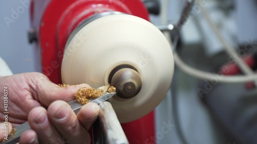 Joinery worker shaping a piece of wood on the lathe