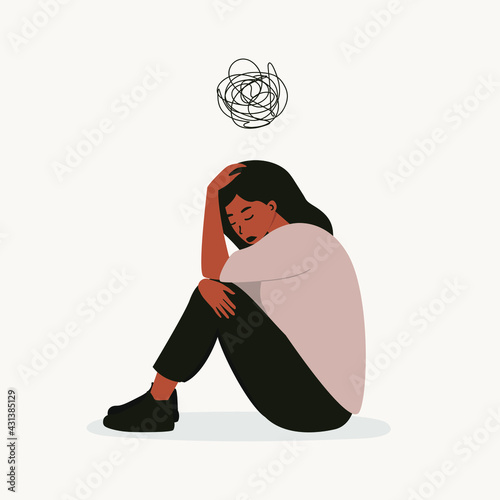 A flat vector cartoon illustration of a woman in a depressed mood, sitting on the floor and holding her knees, scribbling over her head. Mental health problems, burnout, depression.