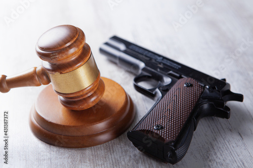 court gavel with a gun on the table