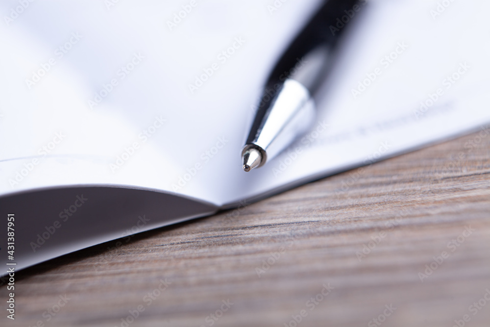 glasses with pen close up and financial report - accounting concept glasses with pen close up and financial report - accounting concept