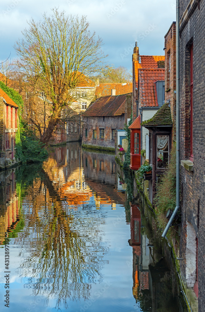 Fototapeta premium Vertical historic city center of Bruges with canals and medieval architecture, Belgium. 