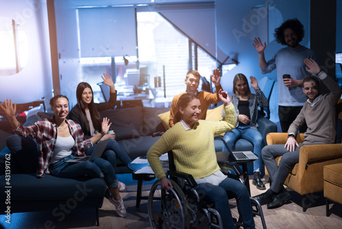 Happy Workers Have Fun in Modern Office, Handicaped Man on Wheelchair. Communication with Colleagues. Teamwork and disability Concept