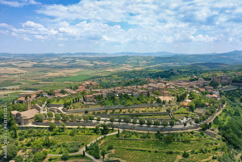 aerial view of the medieval town of montalcino with the surrounding vineyards on the hills in the hills in the province of Siena