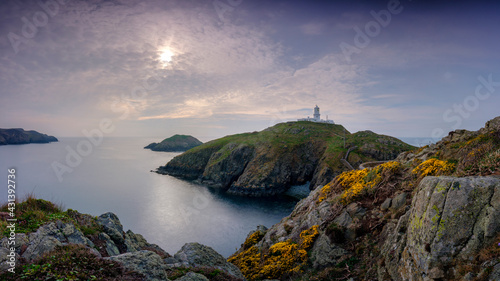 Sunset over Strumble Head light house, Wales, UK photo