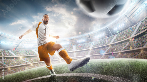 Power soccer kick. A soccer player kicks the ball in stadium. Professional soccer player in action. Wide angle. 3d