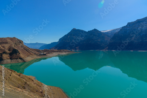 landscape irganay reservoir with blue water and reflections of mountains