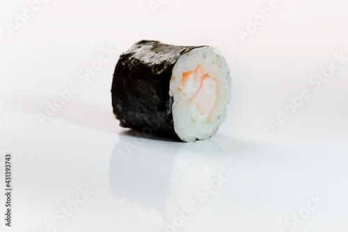 Close up shot of a sushi roll with shrimp. photo