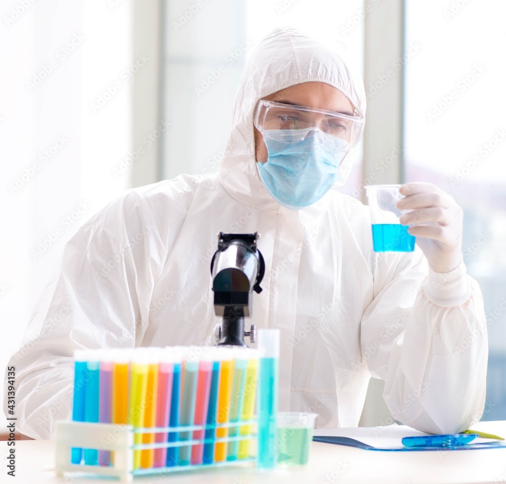 Young chemist student working in lab on chemicals Young chemist student working in lab on chemicals