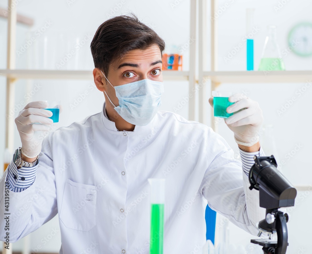 Young chemist student working in lab on chemicals Young chemist student working in lab on chemicals