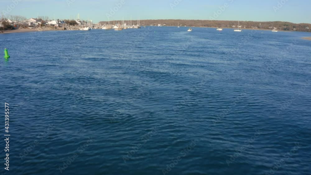 Flying towards a dock full of boats over blue water Flying towards a dock full of boats over blue water