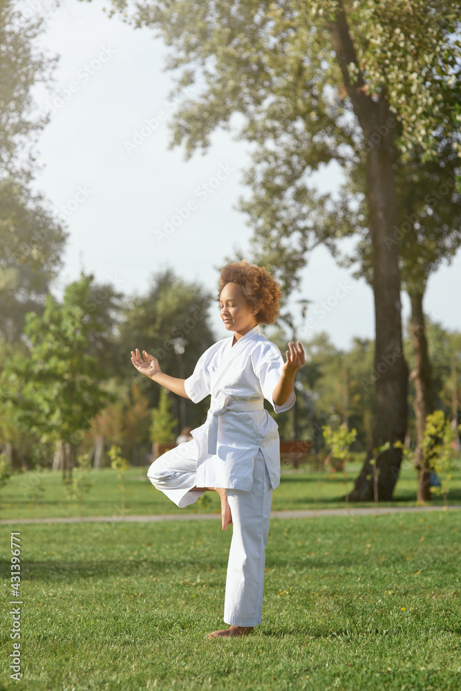Adorable girl karateka doing exercise on the street Adorable girl karateka doing exercise on the street