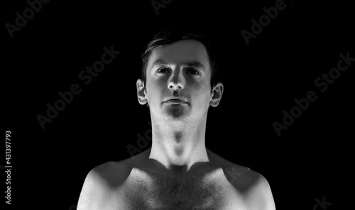 black and white photo portrait of a guy, in dramatic lighting © Serhii  Holdin