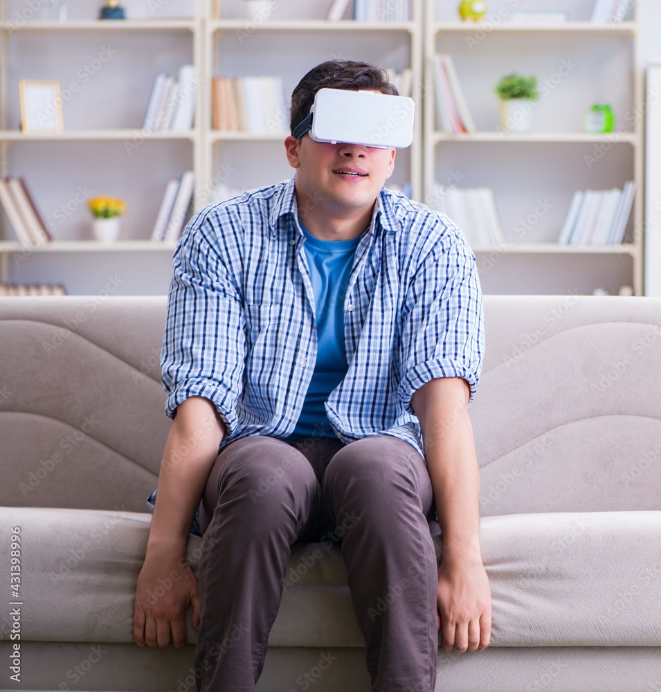 Man with virtual reality glasses playing at home Man with virtual reality glasses playing at home