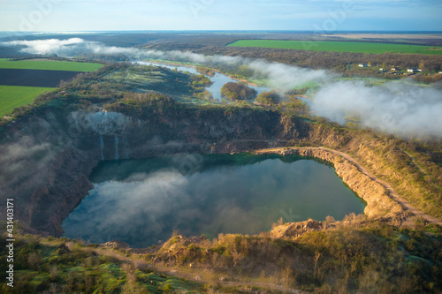 aerial view to the little lake and fog above river in the morning