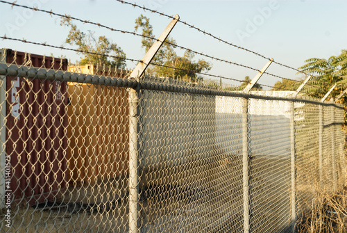 Chain link fence with security wire on top