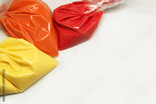 Colorful frosting. Variety of colors of royal icing in plastic piping bags.