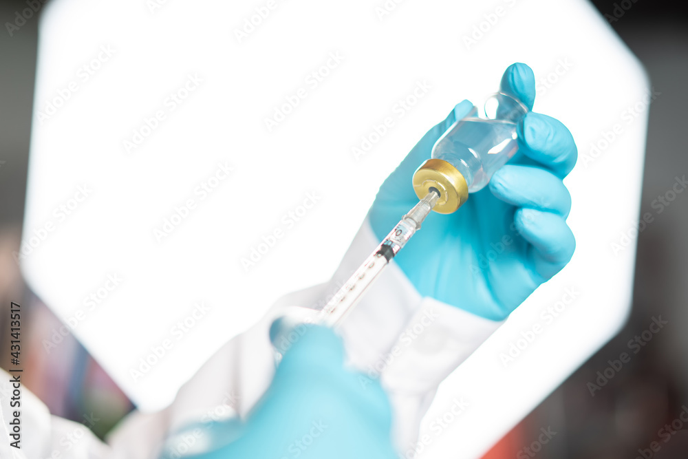 Covid-19 or coronavirus vaccine. Concept fight against virus covid-19 corona virus. Vaccine protect coronavirus outbreak. doctor or scientist in laboratory holding a syringe with liquid vaccines. Covid-19 or coronavirus vaccine. Concept fight against virus covid-19 corona virus. Vaccine protect coronavirus outbreak. doctor or scientist in laboratory holding a syringe with liquid vaccines.