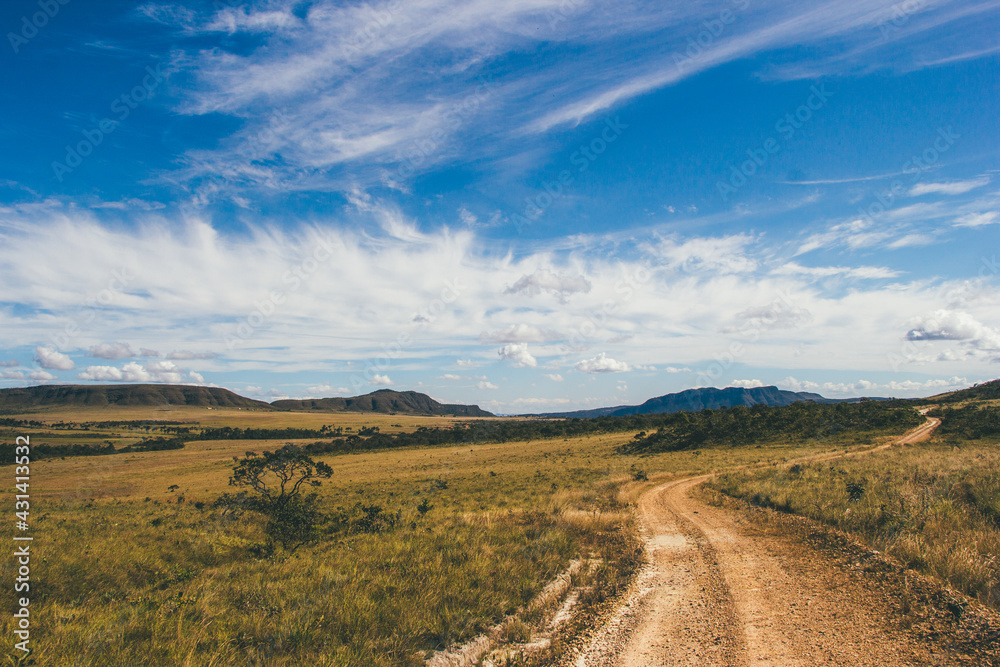 road in the countryside and a blue sky with clouds road in the countryside and a blue sky with clouds