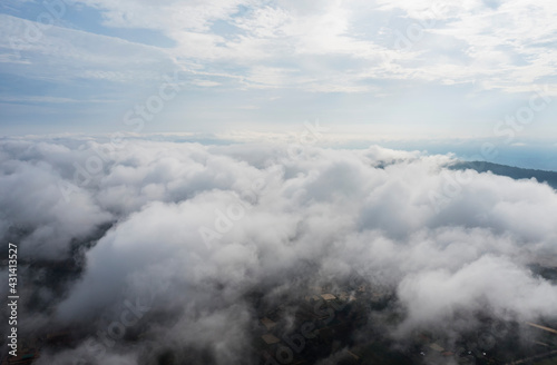 Aerial view Sunrise Beautiful sky with fog clouds. Fantastic foggy landscape glowing while sunrise in the morning. A beautiful landscape with high mountains foggy cover. Dense fog with beautiful light