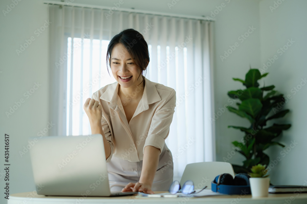 Business female in conference together in an office and excited the success on laptop computer screen. Business female in conference together in an office and excited the success on laptop computer screen.