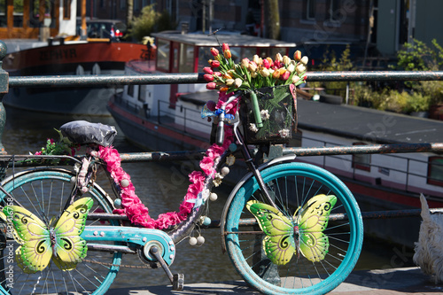 A bicycle decorated with flowers on a canal in Amsterdam.