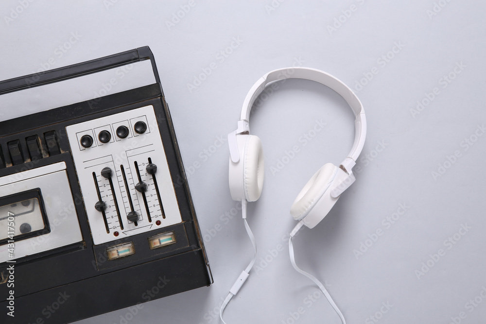 Stereo headphones and audio player with equalizer on a gray background. Top view Stereo headphones and audio player with equalizer on a gray background. Top view