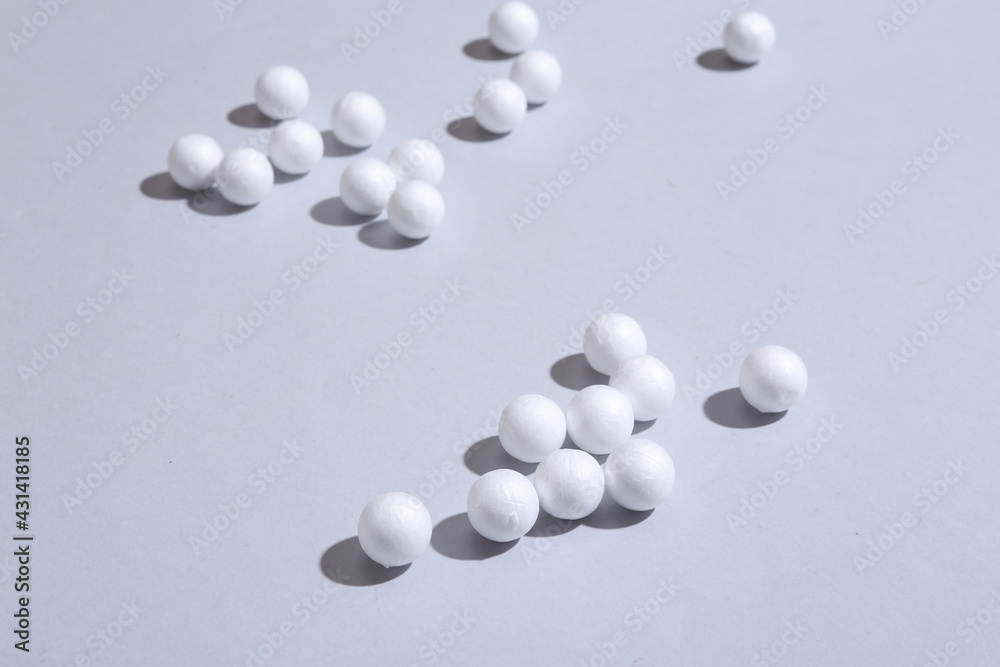 Minimalistic still life of white balls with long trendy shadows on gray background. Abstraction, concept art Minimalistic still life of white balls with long trendy shadows on gray background. Abstraction, concept art