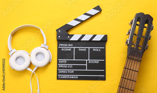 Fotografia, Obraz Guitar, clapperboard and headphones on a yellow background