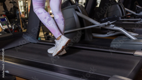 Women's feet on a treadmill. Healthy lifestyle concept. Cardio training