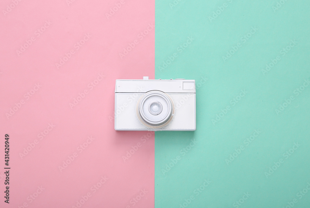 Creative layout. White retro camera on blue pink background. Pastel color trend. Minimalism. Concept art. Modern still life. Flat lay. Top view. Creative layout. White retro camera on blue pink background. Pastel color trend. Minimalism. Concept art. Modern still life. Flat lay. Top view.